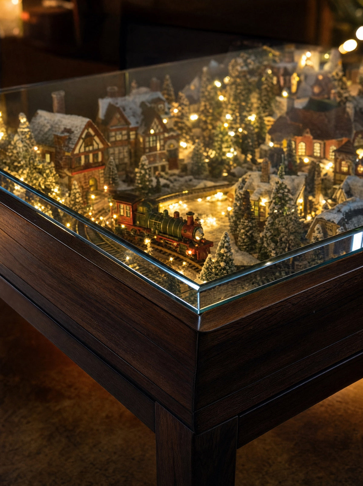 Close-up of the 5 mm tempered glass top with the lit village glowing beneath it